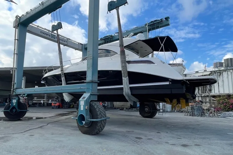 Slide: The Image of 2016 Sea Ray Sundancer 540 yacht in shipyard, lifted by crane for maintenance. - 98
