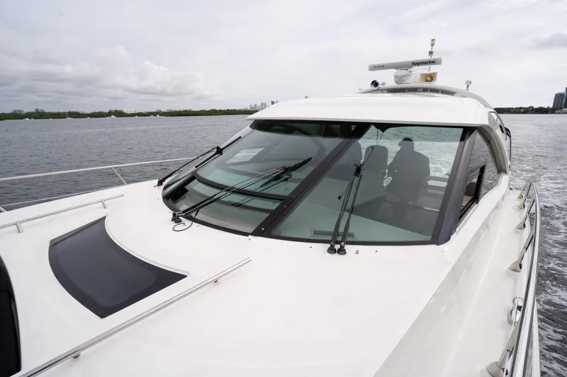 Slide: The Image of 2016 Sea Ray Sundancer 540 yacht cruising on calm waters. - 17