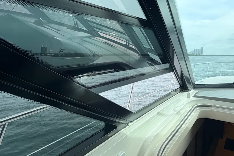 Slide: The Image of 2016 Sea Ray Sundancer 540 yacht interior with ocean view through large windows. - 19