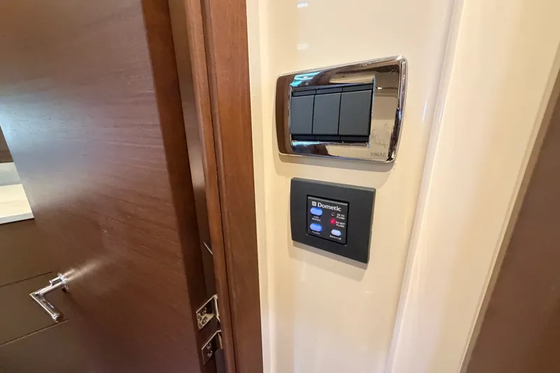Slide: The Image of Control panel and switches inside a 2016 Sea Ray Sundancer 540 yacht. - 83