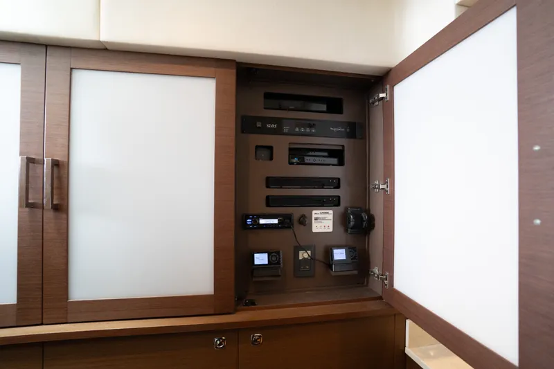 Slide: The Image of 2016 Sea Ray Sundancer 540 interior electronics cabinet with modern equipment and sleek design. - 55