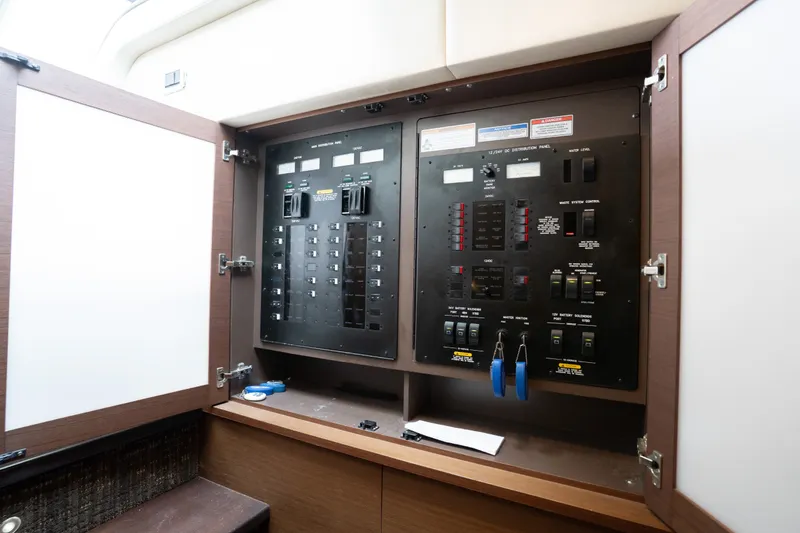 Slide: The Image of Electrical control panel inside 2016 Sea Ray Sundancer 540 yacht, featuring switches and indicators. - 54