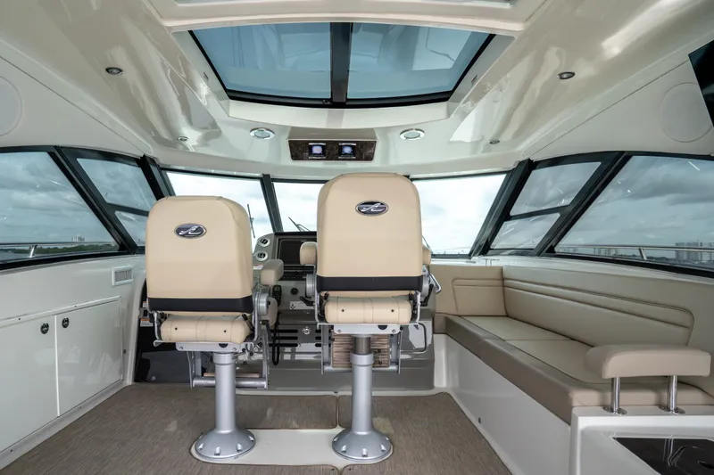 Slide: The Image of Interior of 2016 Sea Ray Sundancer 540 yacht with helm seats and panoramic windows. - 29
