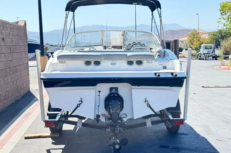Slide: The Image of 2011 Bayliner 185 Bowrider boat on trailer, rear view, outdoors. - 4