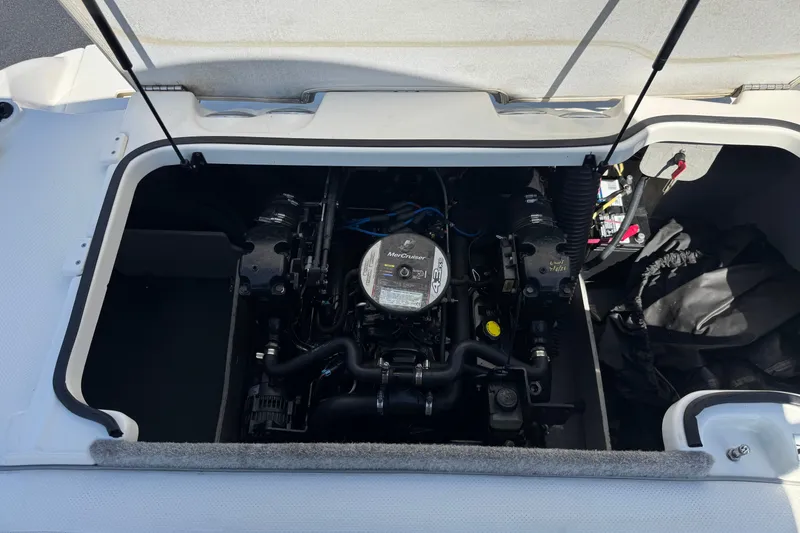 Slide: The Image of 2011 Bayliner 185 Bowrider engine compartment with MerCruiser engine visible. - 16