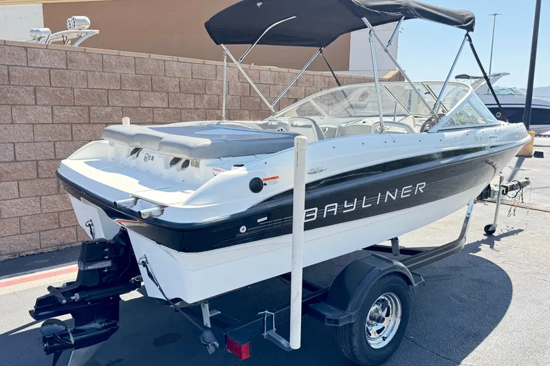 Slide: The Image of 2011 Bayliner 185 Bowrider boat on trailer, featuring sleek design and black accents. - 5