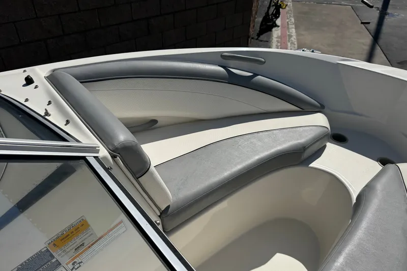 Slide: The Image of 2011 Bayliner 185 Bowrider boat interior with gray and white seating. - 11