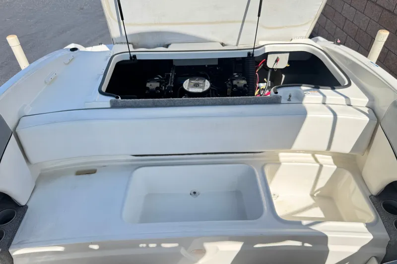 Slide: The Image of 2011 Bayliner 185 Bowrider engine compartment with open hatch, showcasing interior details. - 15