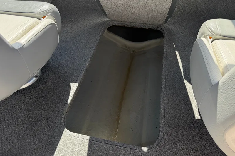 Slide: The Image of Interior view of a 2011 Bayliner 185 Bowrider boat, showing storage compartment. - 19