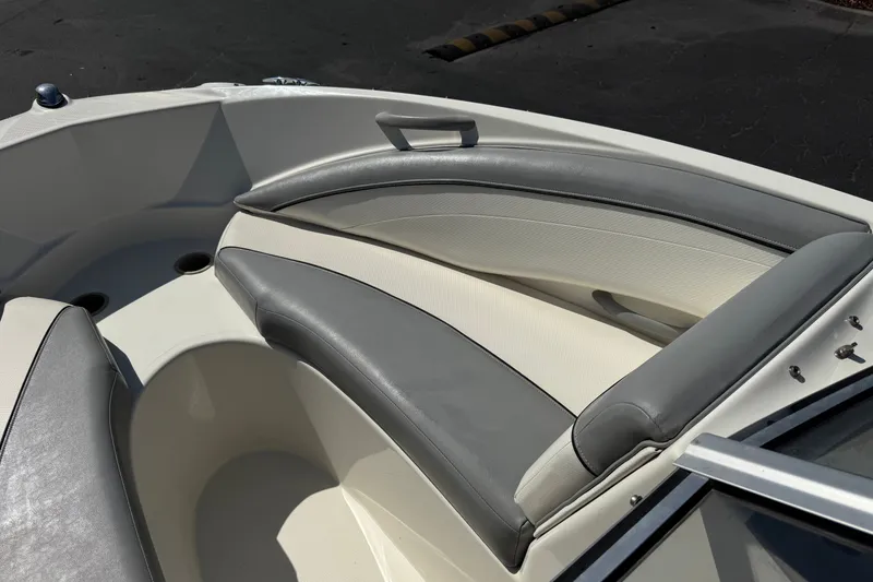 Slide: The Image of 2011 Bayliner 185 Bowrider interior with gray and white seating. - 12