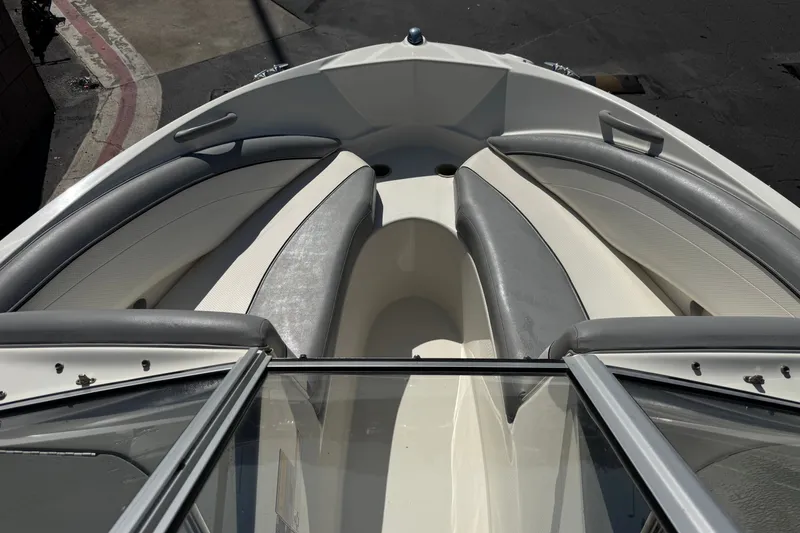 Slide: The Image of 2011 Bayliner 185 Bowrider boat interior with gray and white seating. - 10