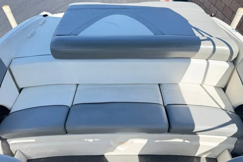 Slide: The Image of 2011 Bayliner 185 Bowrider boat seating, featuring gray and white cushioned upholstery. - 14