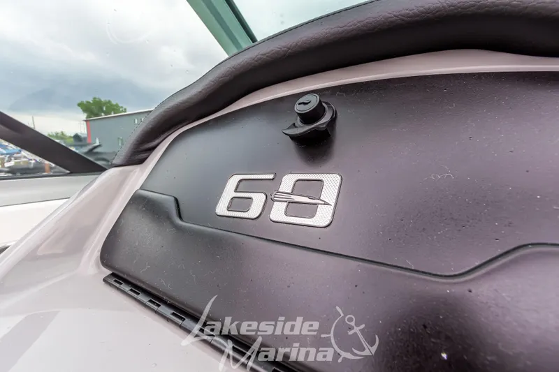 Slide: The Image of 2025 Chaparral 21 SSi dashboard with "60" emblem at Lakeside Marina. - 29