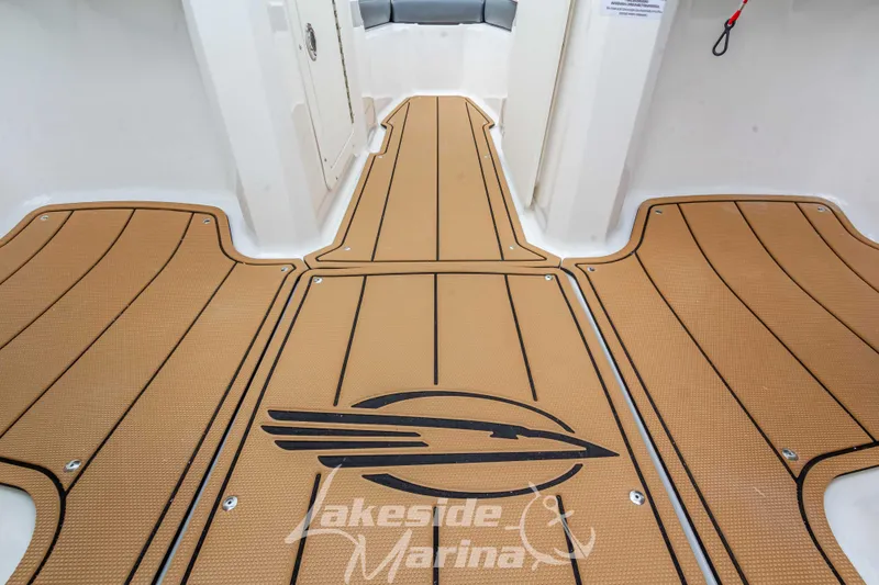 Slide: The Image of 2025 Chaparral 21 SSi boat interior with custom flooring and logo design. - 23