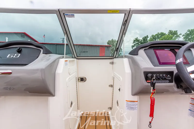 Slide: The Image of 2025 Chaparral 21 SSi boat dashboard with modern controls and steering wheel. - 31