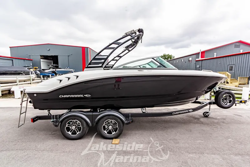 Slide: The Image of 2025 Chaparral 21 SSi boat on trailer at marina, side view. - 3