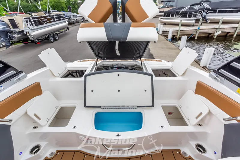 Slide: The Image of 2025 Chaparral 21 SSi boat interior with open storage compartments at marina. - 17