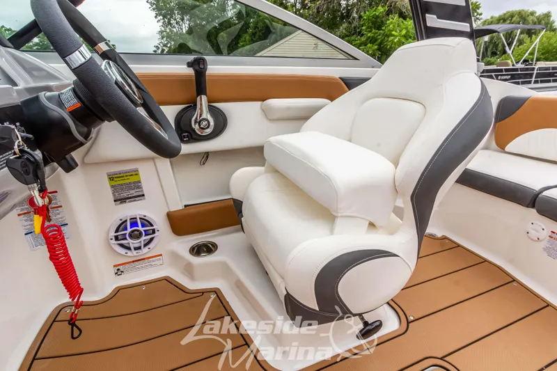 Slide: The Image of 2025 Chaparral 21 SSi boat interior with steering wheel and plush seating. - 27