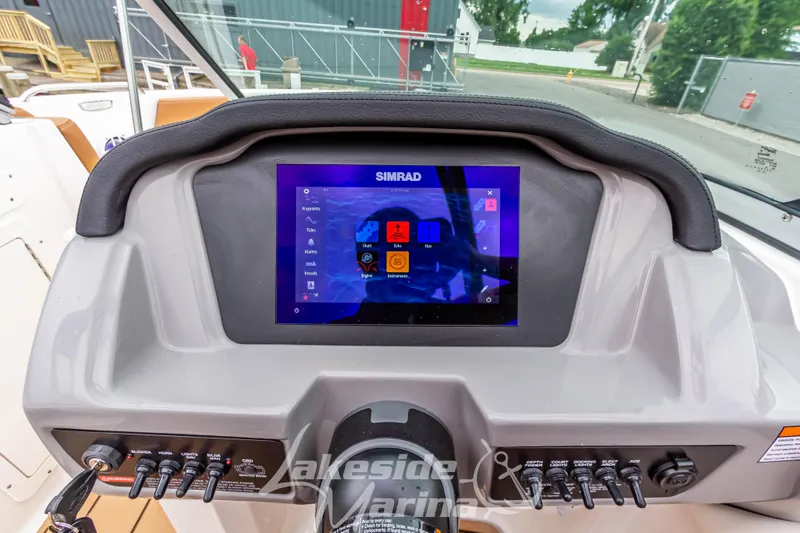 Slide: The Image of 2025 Chaparral 21 SSi boat dashboard with Simrad display and control panel. - 25