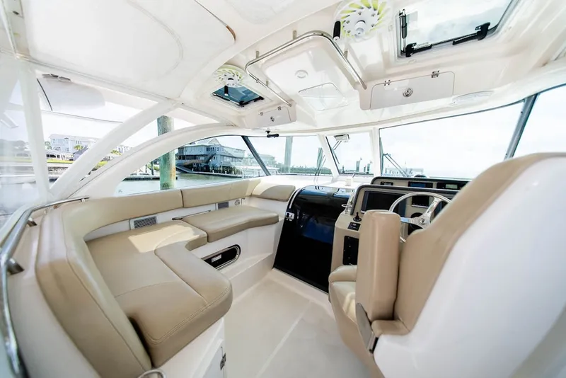 Slide: The Image of Interior of 2015 Pursuit OS 385 Offshore boat with luxurious seating and modern controls. - 16