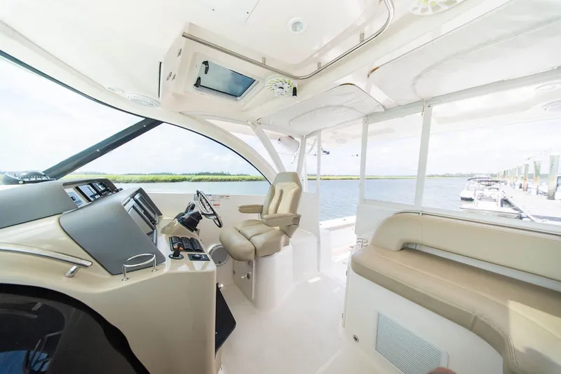 Slide: The Image of Interior view of 2015 Pursuit OS 385 Offshore boat, featuring helm and seating area. - 19