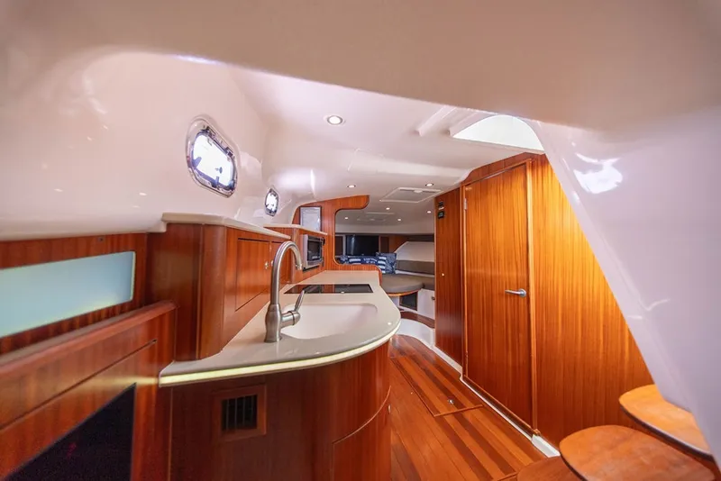 Slide: The Image of Luxurious interior of 2015 Pursuit OS 385 Offshore yacht with wood finishes and modern amenities. - 24