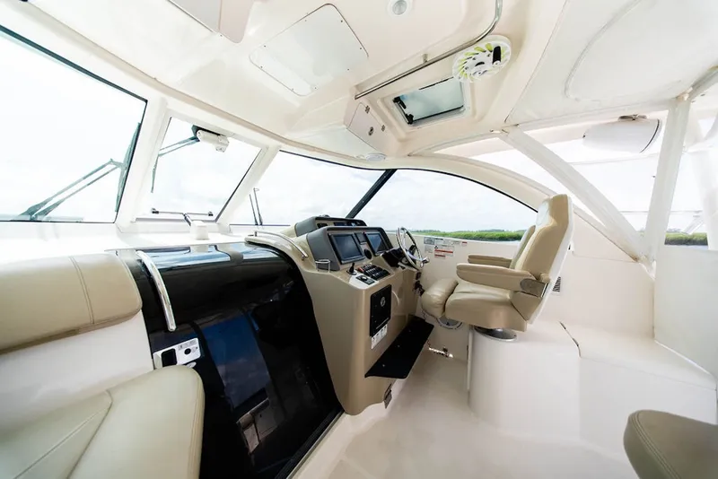 Slide: The Image of Interior of 2015 Pursuit OS 385 Offshore boat with modern helm and seating. - 15