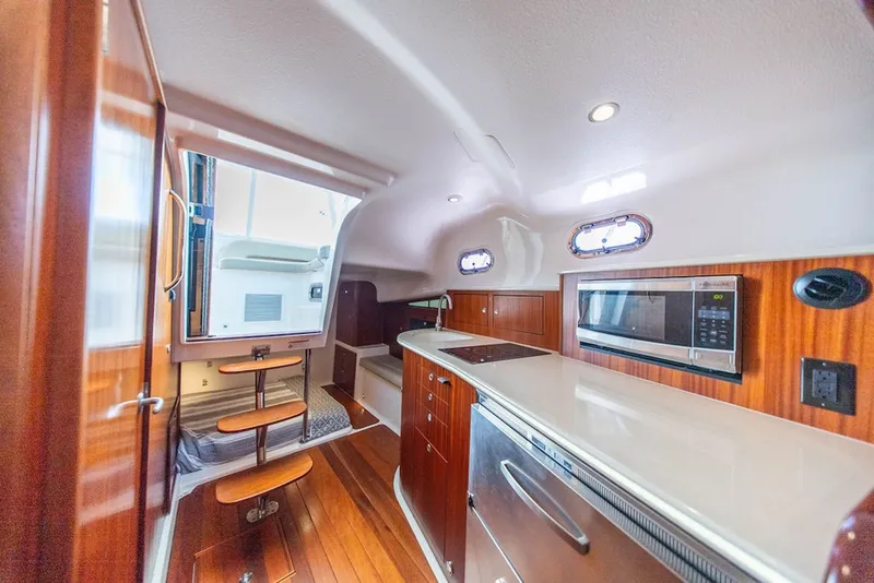 Slide: The Image of Luxurious interior of 2015 Pursuit OS 385 Offshore yacht with modern kitchen amenities. - 25