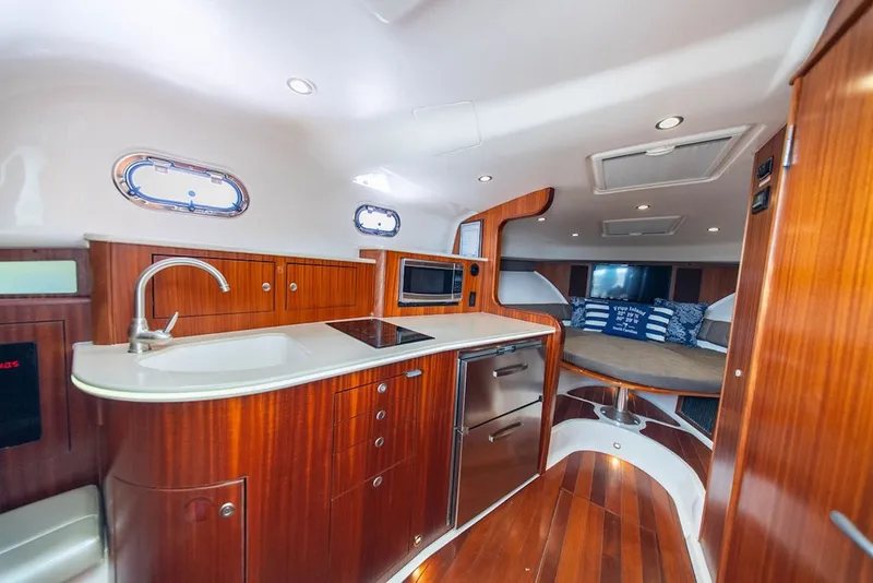 Slide: The Image of Luxurious interior of 2015 Pursuit OS 385 Offshore yacht with modern kitchen and cozy seating area. - 23