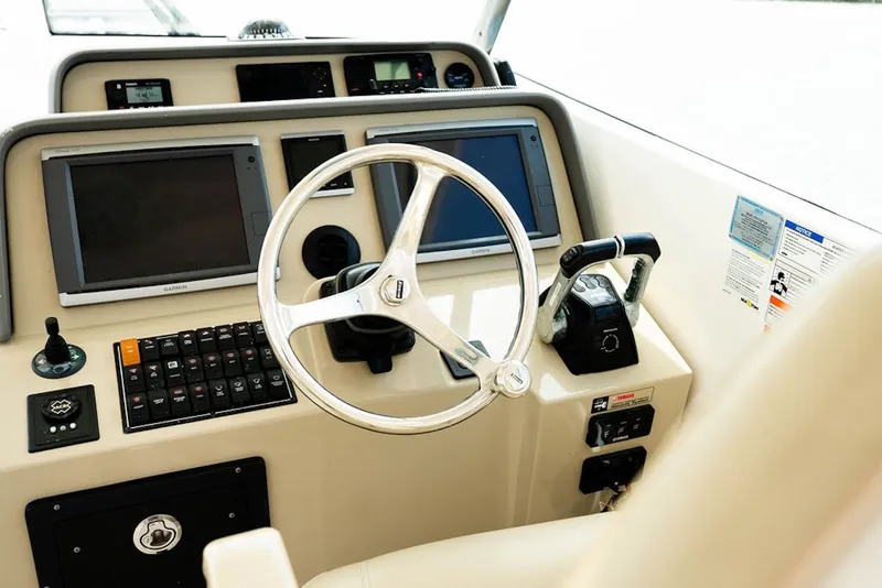 Slide: The Image of Helm of 2015 Pursuit OS 385 Offshore boat with modern controls and navigation displays. - 20