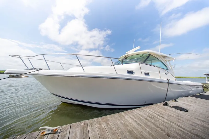 Slide: The Image of 2015 Pursuit OS 385 Offshore boat docked on a sunny day. - 3
