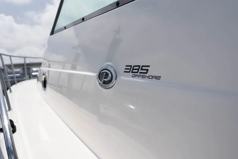 Slide: The Image of 2015 Pursuit OS 385 Offshore boat exterior with logo and model name. - 6