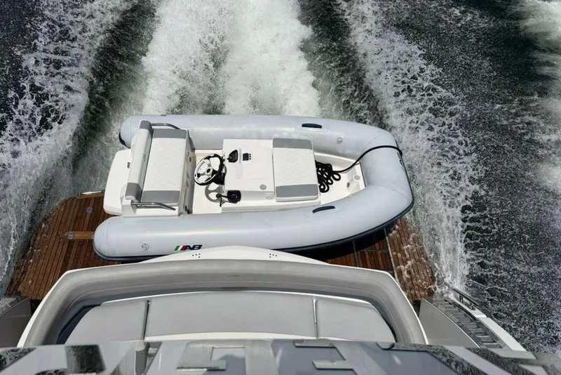 Slide: The Image of 2021 Galeon 500 Fly yacht with inflatable boat on water. - 67