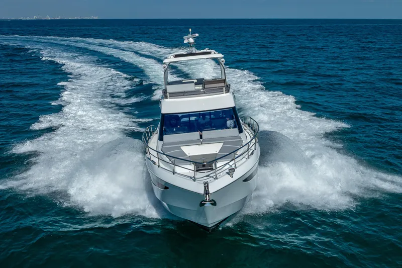 Slide: The Image of 2021 Galeon 500 Fly yacht cruising on open sea, creating dynamic water trails. - 20