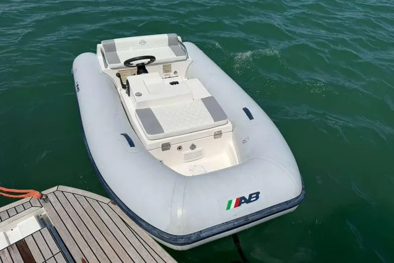 Slide: The Image of Inflatable boat docked on water near a wooden platform. - 66