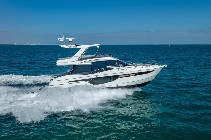 Slide: The Image of 2021 Galeon 500 Fly yacht cruising on open sea under clear blue sky. - 18