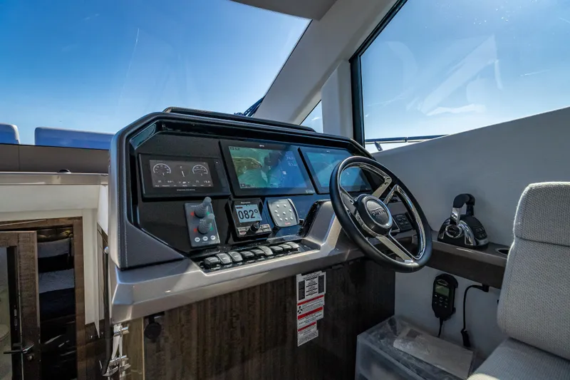 Slide: The Image of Cockpit of 2021 Galeon 500 Fly yacht with modern navigation controls and steering wheel. - 41