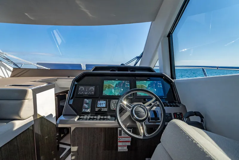 Slide: The Image of Helm of 2021 Galeon 500 Fly yacht with modern navigation displays and ocean view. - 42