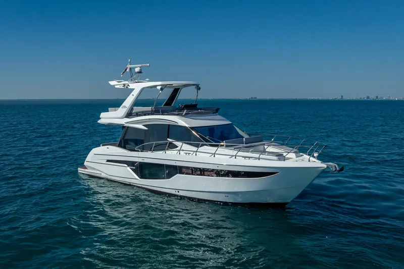 Slide: The Image of 2021 Galeon 500 Fly yacht cruising on open blue sea under clear sky. - 17