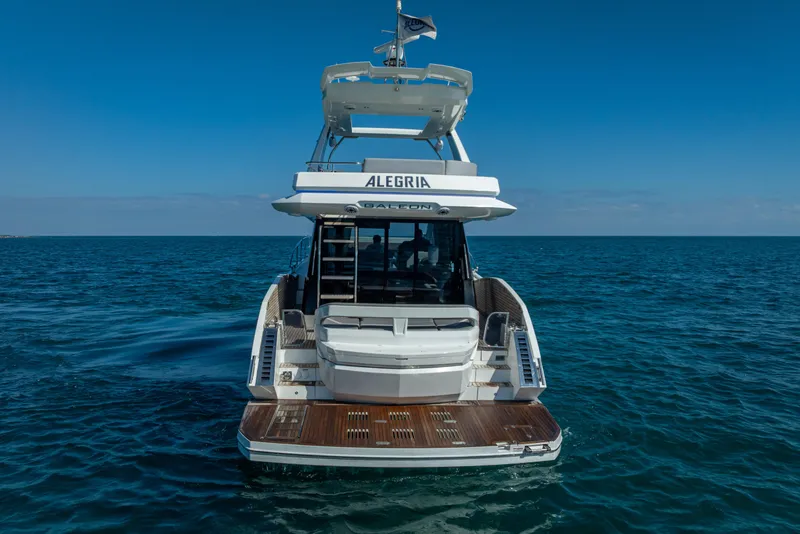 Slide: The Image of 2021 Galeon 500 Fly yacht on open sea, rear view. - 14