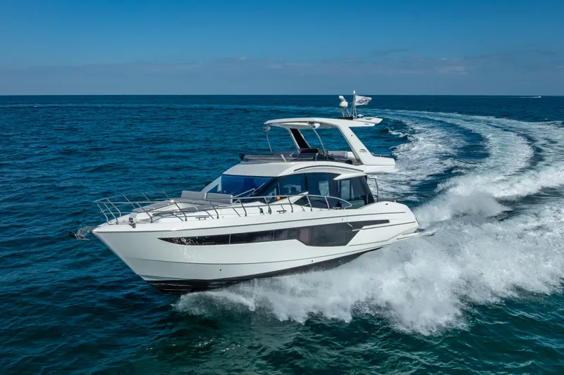 The Image of 2021 Galeon 500 Fly yacht cruising on open sea, creating waves. - 0
