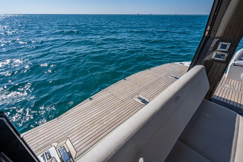 Slide: The Image of 2021 Galeon 500 Fly yacht deck overlooking serene ocean waters. - 48