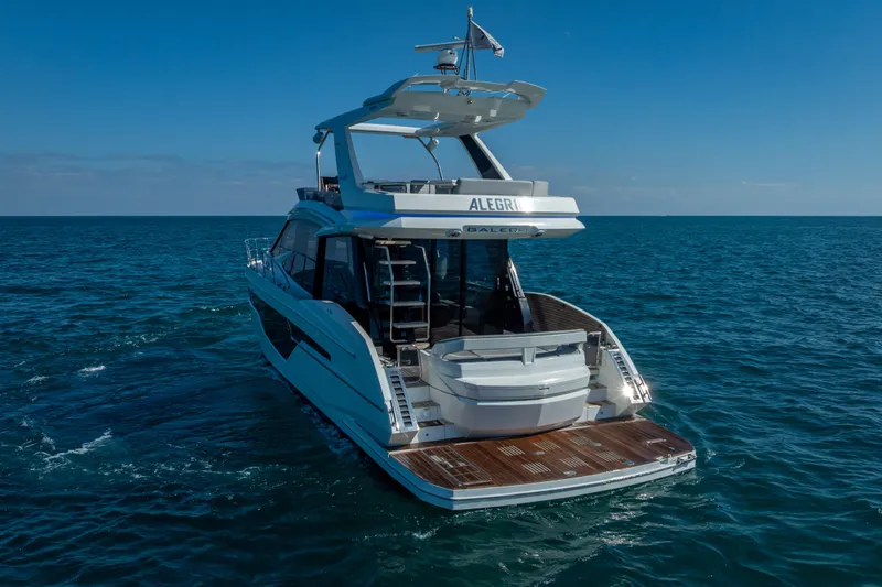 Slide: The Image of 2021 Galeon 500 Fly yacht cruising on open sea under clear blue sky. - 53