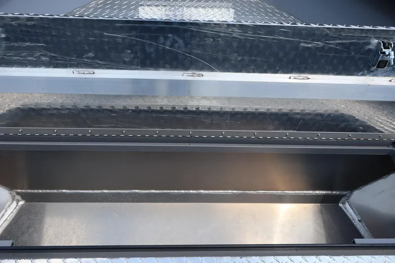 Slide: The Image of Open storage compartment of 2026 Alumaweld Columbia 21 boat, featuring metal construction. - 16