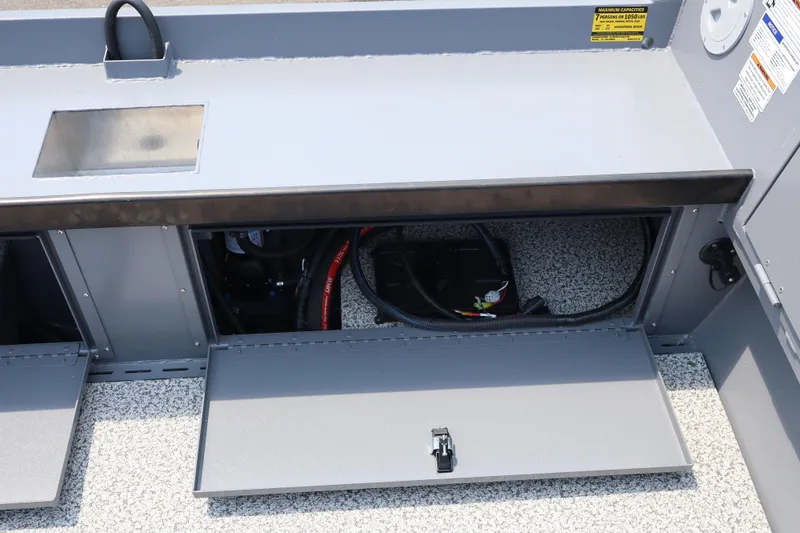 Slide: The Image of Open storage compartment in 2026 Alumaweld Columbia 21 boat, showcasing interior wiring and components. - 10