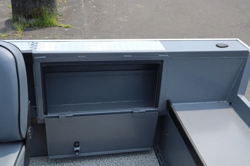 Slide: The Image of 2026 Alumaweld Columbia 21 boat interior storage compartment with sleek gray finish. - 9