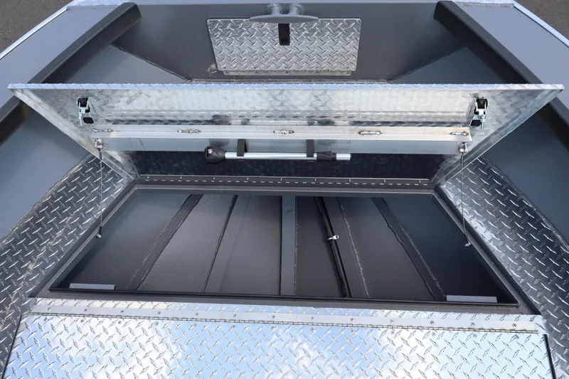 Slide: The Image of Open storage compartment of 2026 Alumaweld Columbia 21 boat with diamond plate finish. - 17