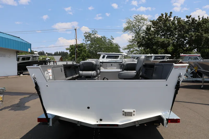 Slide: The Image of 2026 Alumaweld Columbia 21 boat, rear view, parked outdoors under a clear sky. - 4