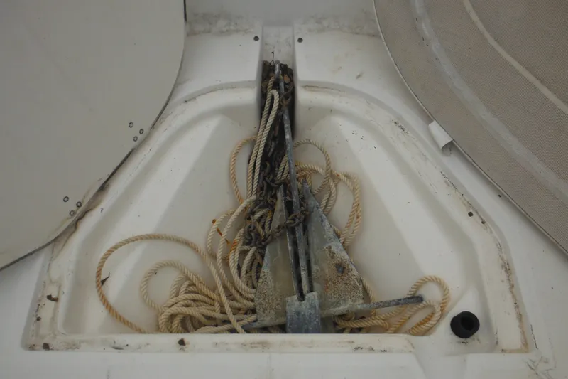 Slide: The Image of Anchor storage compartment on a 2003 Boston Whaler 220 Dauntless boat with ropes. - 23