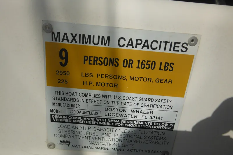 Slide: The Image of 2003 Boston Whaler 220 Dauntless capacity plate: 9 persons, 1650 lbs, 225 HP motor. - 42